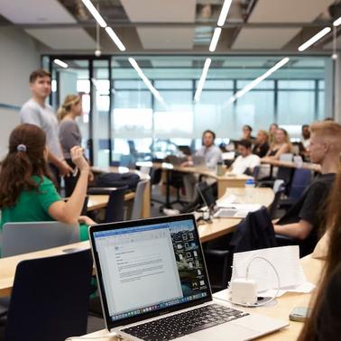 A classroom setting with students engaged in a presentation.