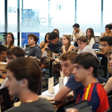A diverse group of students attentively listening in a classroom setting.