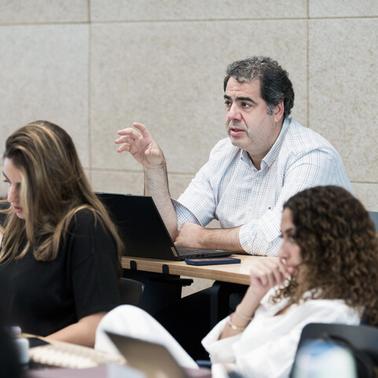 A group of people attentively listening to a speaker during a seminar.