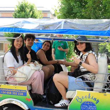 A group of four people enjoying a ride in a tuk-tuk.
