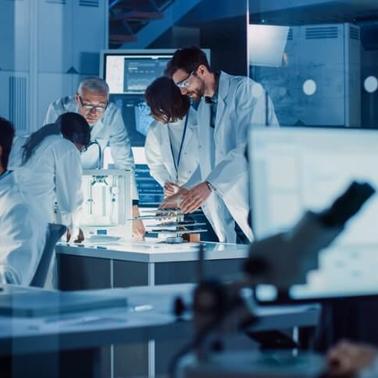 A group of scientists collaborating in a modern laboratory, analyzing data and discussing over a microscope.