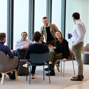 A group of professionals having a meeting in a modern office setting.