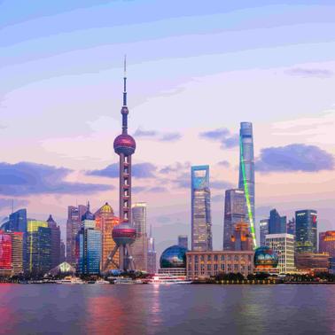 A vibrant skyline of Shanghai illuminated at sunset.