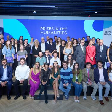 A large group of people posing for a photo at an event celebrating humanities prizes.