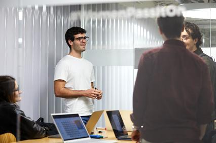 A group of people involved in a discussion in a modern office environment