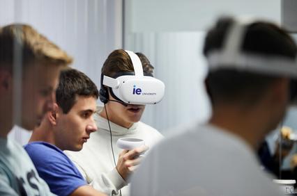 A group of young men are engaging with virtual reality headsets in a modern educational setting.