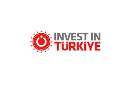 Logo of 'Invest in Türkiye' featuring a red and white color scheme with a circular design and a crescent moon symbol.