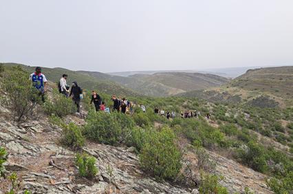 A group of people hiking through a mountainous landscape.