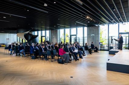 A group of people attending a conference in a modern building.