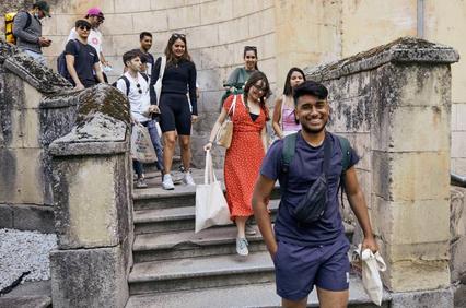 A group of people walking down a stairway in a casual setting.