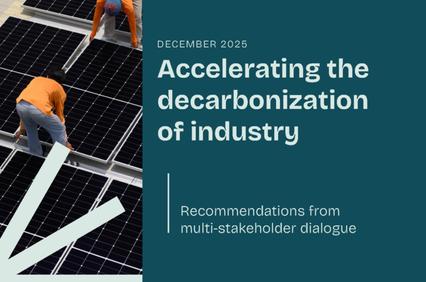 The image features workers installing solar panels on a rooftop, highlighting renewable energy efforts.
