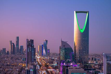 A stunning skyline view of Riyadh at dusk featuring modern architecture and vibrant lighting.