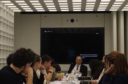 A group of people sitting around a conference table engaged in a discussion.