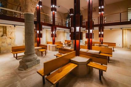 A modern interior space with wooden benches and contemporary lighting.