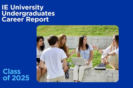 A group of five university students engaged in a lively discussion outdoors.