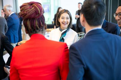 A group of people engaging in a lively conversation at a social event.