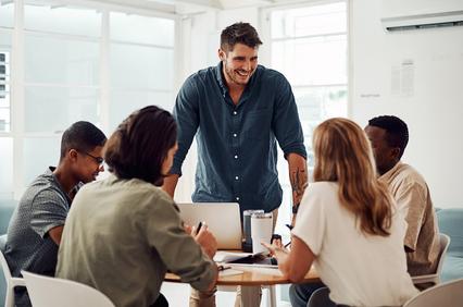 A group of people collaborating in a modern office setting.