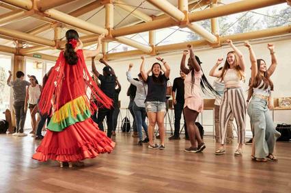 A group of people enjoying a dance performance in a lively setting.
