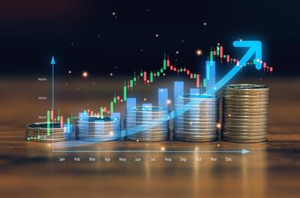 The image illustrates a financial growth chart with stacked coins in the foreground.