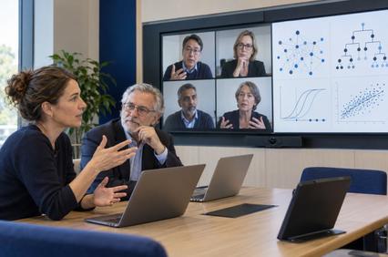 A diverse group of professionals engaged in a discussion during a virtual meeting.