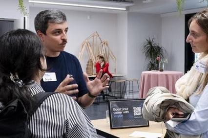 A group of people engaging in a conversation at an event.