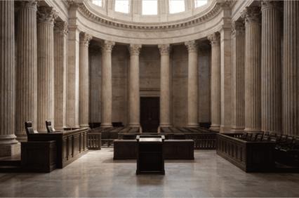 A grand courtroom featuring tall columns and wooden furniture.