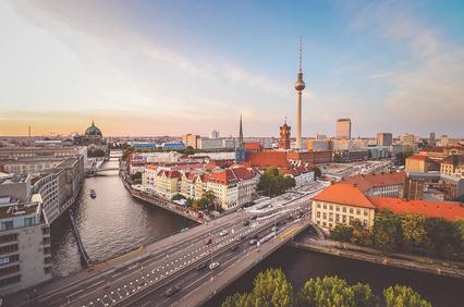 A panoramic view of Berlin featuring the TV Tower and historic buildings along the river.