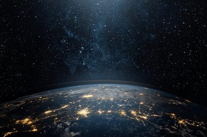 A stunning view of Earth from space, showcasing city lights against a backdrop of stars.