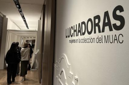 People visiting an art exhibition titled 'Luchadoras' at the MUAC museum.