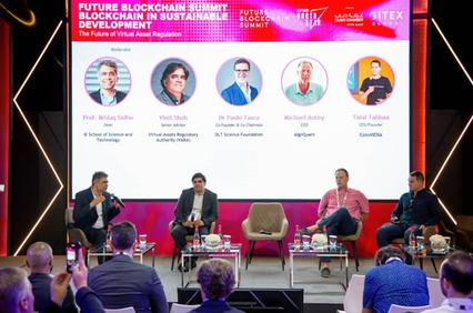 A panel discussion on blockchain regulation with multiple speakers at a conference.