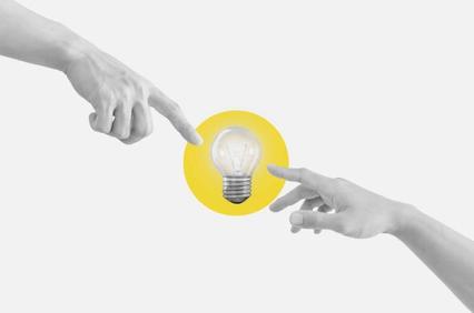 Two hands reaching towards each other with a lightbulb in the center.