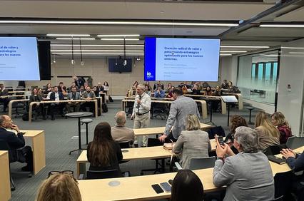 A conference room filled with attendees engaged in a presentation.