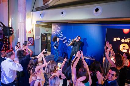 A lively performance with an enthusiastic audience clapping and cheering.