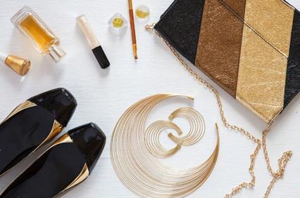 A stylish arrangement of fashion accessories including shoes, a clutch, jewelry, and cosmetics.