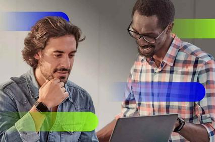 Two men, one looking at a tablet and discussing something with a coworker.