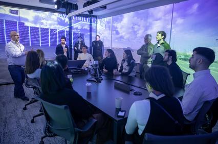 A group of people engaged in a discussion in a modern conference room.
