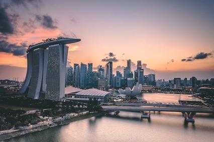 A stunning skyline of Singapore at sunset with modern architecture along the waterfront.
