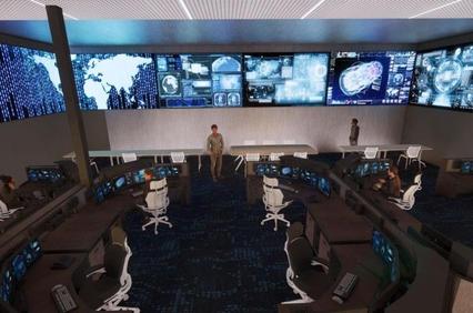 A modern command center featuring multiple digital screens and workstations.