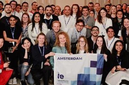 A large group of people gathered together celebrating an event in Amsterdam.