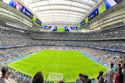 A panoramic view of a large stadium filled with fans during a sporting event.