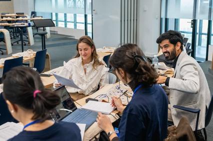 A group of people engaging in a collaborative work session at a modern office space.