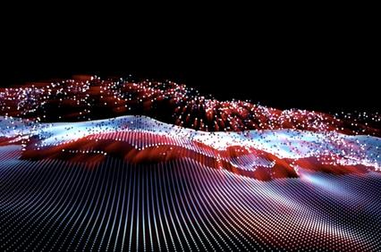 A colorful wave of illuminated particles representing dynamic movement and energy.