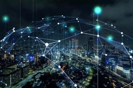A futuristic city skyline connected by a digital network of lights and nodes.