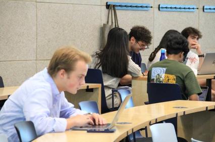 A group of students working collaboratively in a classroom setting.