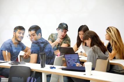 A group of students engaged in a collaborative study session in a classroom.