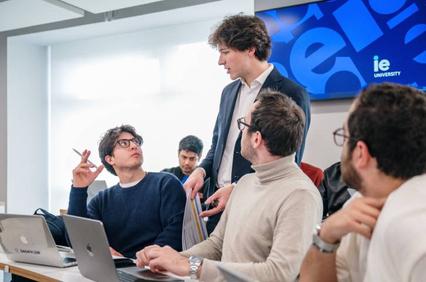 A group of students engaged in a discussion in a modern classroom.