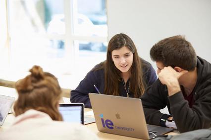 A group of university students collaborating on a project at a table.