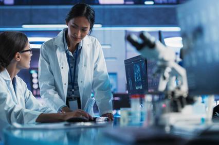 Two scientists are collaborating in a modern laboratory setting.