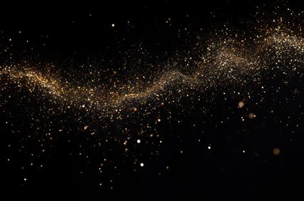 A shimmering golden dust scattered against a dark background.