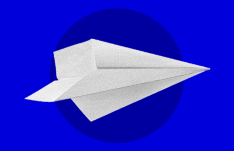 A white paper airplane on a blue background.